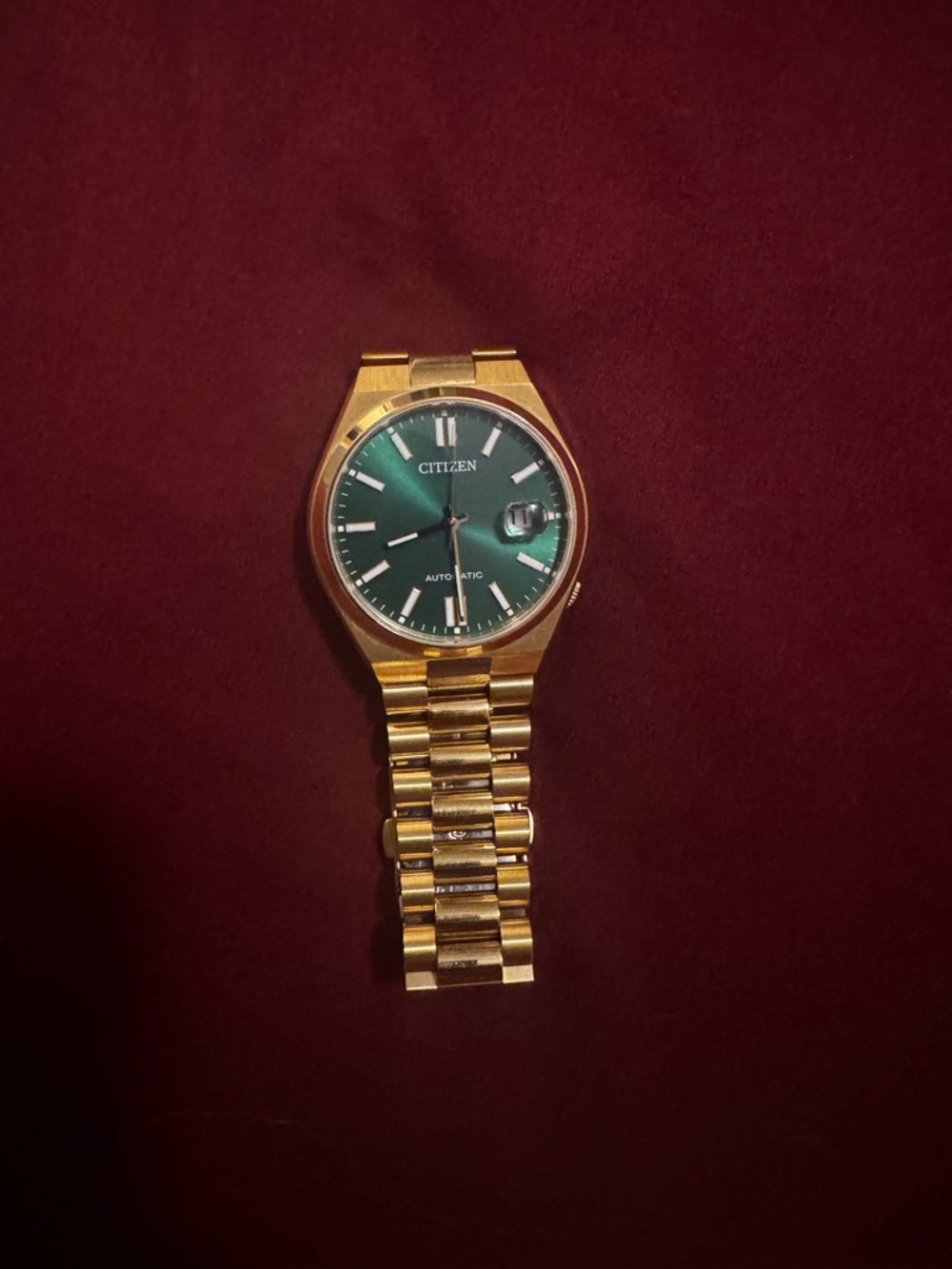 Men’s Gold with green dial automatic watch.